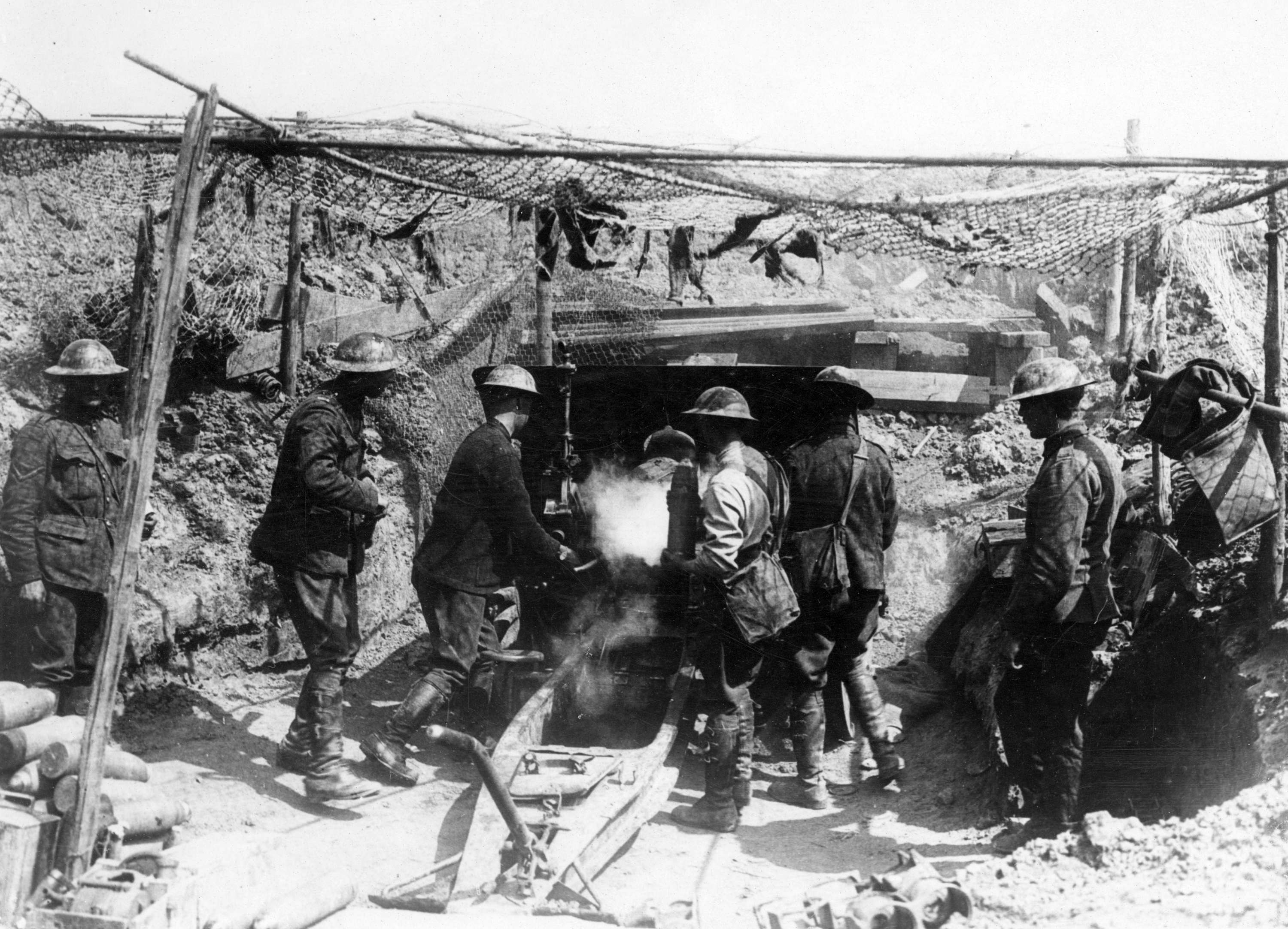 soldiers firing artillery into a dugout.jpg