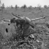 A Canadian infantryman examining an earth-emplaced German 88mm anti-tank gun in the Hitler Line near Aquino, Italy, 25 May 1944.