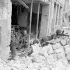 Riflemen of The Regina Rifle Regiment holding a position in a damaged storefront, Caen, France, 10 July 1944.