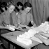 Nursing sisters of the Royal Canadian Army Medical Corps (R.C.A.M.C.) rolling bandages in a British hospital in the Normandy bridgehead, France, 17 July 1944.