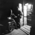 Corporal Joe Babcock (left) talking with Private Herb Thompson, both of the Canadian Provost Corps, at Provost Detachment Headquarters before starting his nightly motorcycle patrol of Taormina, Italy, December 1943.