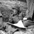 Major Geoff Boone, Brigade Major of the 8th Canadian Infantry Brigade, reading a newspaper during German shelling, Carpiquet, France, 6 July 1944.