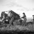 Lieutenant J.A.R. Gregoire leading a patrol past a disabled German halftrack vehicle in the Normandy beachhead, France, 10 June 1944.