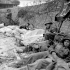 Wounded Canadian soldiers awaiting evacuation to a Casualty Clearing Station of the Royal Canadian Army Medical Corps (R.C.A.M.C.) in the Normandy beachhead, France, 6 June 1944.