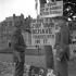 Two unidentified Canadian non-commissioned officers reading a sign which states, “This is a 2 Div Town - Behave Yourselves In It”, Dieppe, France, 9 September 1944.