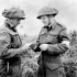 H/Captain Robert L. Seaborn, Chaplain of the 1st Battalion, The Canadian Scottish Regiment, distributing New Testaments near Caen, France, 15 July 1944.