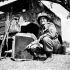 Sergeant R.A. Garbutt of the 19th Field Regiment, Royal Canadian Artillery (R.C.A.), showing shrapnel holes in the radiator of his vehicle made by a German 88mm. anti-tank gun in Normandy, France, 16 June 1944.