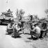 Major Irwin, Officer Commanding "C" Squadron, The Ontario Regiment, conferring with personnel of the squadron on the right flank of the Paterno front, Italy, 3 August 1943.