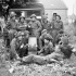 H/Captain John M. Anderson, Chaplain of The Highland Light Infantry of Canada, with members of the unit's Regimental Aid Party listening to a gramophone, Caen, France, 15 July 1944.