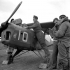Captain A.G. Dick receives final instructions from Captain Pat Henderson as Leading Aircraftsmen Robert Ducroq and E.J. Edwards service his Taylorcraft Auster A.O.P. III aircraft of the Royal Air Force, Orsogna, Italy, February 1944.