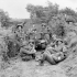 Infantrymen of Le Régiment de la Chaudière resting behind a Universal Carrier in a low ground position in the Normandy beachhead, France, ca. 8-9 June 1944.