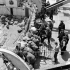 A wounded Royal Navy Beach Commando being taken aboard H.M.C.S. PRINCE DAVID off the Normandy beachhead, France, 6 June 1944.