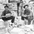 Private W. Sutherland (left) of The Westminster Regiment (Motor) and Private V.A. Keddy of The Cape Breton Highlanders repacking compo rations at a supply depot, Cassino, Italy, 18 April 1944.