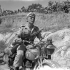 Despatch rider Private H. McDowell of The 48th Highlanders of Canada delivering a message to the battalion's advanced headquarters, Regalbuto, Italy, 4 August 1943.