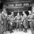 Personnel of the Canadian Provost Corps outside "The Pop Inn", the new Navy, Army and Air Force Institute (N.A.A.F.I.)  canteen, Caen, France, 27 July 1944.