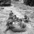 Troopers of the 12th Manitoba Dragoons playing cards near Caen, France, 19 July 1944.