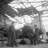 Unidentified Canadian officers examining a damaged Henschel Hs 129 aircraft of the Luftwaffe, Carpiquet, France, 12 July 1944.