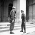 Brigade Major N. Kingsmill (left) presenting Brigadier D.G. Cunningham, who is relinquishing command of the 9th Canadian Infantry Brigade, with the first Canadian flag that was raised in Caen during the liberation of that city. Caen, France, 11 July 1944.