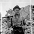 Private H. Koebe of the 9th Canadian Infantry Brigade helping to clear rubble, Carpiquet, France, 12 July 1944.