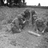 Unidentified sappers of the Royal Canadian Engineers (R.C.E.) examining an unexploded German 15.5 cm. shell, Caen, France, 10 July 1944.