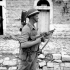 Corporal E.H. Pruner of The Hastings and Prince Edward Regiment, who carries both a PIAT anti-tank weapon and a Thompson sub-machine gun, Motta, Italy, 2 October 1943.