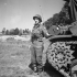 Major Harry L. Thorne of the 13th Field Regiment, Royal Canadian Artillery (R.C.A.), standing in front of a Priest M-7 105mm. self-propelled gun, Normandy, France, 25 June 1944.