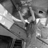 Petty Officer Shipwright R. Abernethy repairing mine damage to one of the Landing Craft Assault (LCA) of H.M.C.S. PRINCE HENRY on D-Day, France, 6 June 1944.