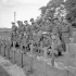 Major J.M. Figott and members of his company of the Royal Hamilton Light Infantry kneeling at the graves of Canadian soldiers killed at Dieppe on 19 August 1942. Dieppe, France, 1 September 1944.