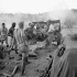 Gunners of the 7th Battery, 2nd Field Regiment, Royal Canadian Artillery (R.C.A.), firing their 25-pounder guns at German positions, Nissoria, Italy, 23-28 July 1943.