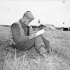 Able Seaman George Vilneff, W-1 Party, Royal Canadian Navy Beach Commando “W”, writing a letter in the Juno sector of the Normandy beachhead, France, 20 July 1944.