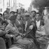Private Dave King, a driver with the Canadian Army Film and Photo Unit, talking with an Italian who lived in his own hometown of Burlington, Ontario, for a number of years, Delianuova, Italy, ca. 5 September 1943.