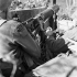 An unidentified gunner of the Saskatoon Light Infantry (M.G.) laying down harassing fire with a Vickers machine gun near Ortona, Italy, 7 January 1944.