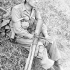 Private Stanley Rodgers of the 48th Highlanders of Canada, who holds a PIAT anti-tank weapon, resting north of the Conca River en route to Rimini, Italy, September 1944.