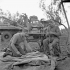 Private W.A. Lloyd repairs a tarpaulin while Lance-Corporal W.L. Milburn mends rope, 1st Infantry Brigade Workshop, Royal Canadian Electrical and Mechanical Engineers (R.C.E.M.E.), San Leonardo di Ortona, Italy, 13 December 1943.