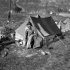 Private Albert Vincent, Royal Canadian Ordnance Corps (R.C.O.C.), emerges from his tent north of Ortona, Italy, 15 February 1944.