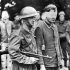 An unidentified Canadian soldier, who is armed with a Thompson machine gun, escorting a German prisoner who was captured during Operation JUBILEE, the Dieppe raid. England, 19 August 1942.