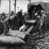 Unloading 15 inch Howitzer shells. Photographer Captain James Francis "Frank" Hurley.