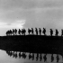 Infantry moving forward to take over the front line at evening. Photographer Captain James Francis "Frank" Hurley.