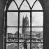 Looking out of a ruined cathedral window on to the graves of the fallen. Photographer Captain James Francis "Frank" Hurley.